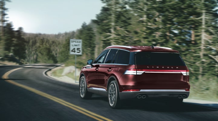 A 2024 Lincoln Aviator® SUV is being driven on a winding mountain road | Dutch Miller Lincoln of Ashland in Ashland KY