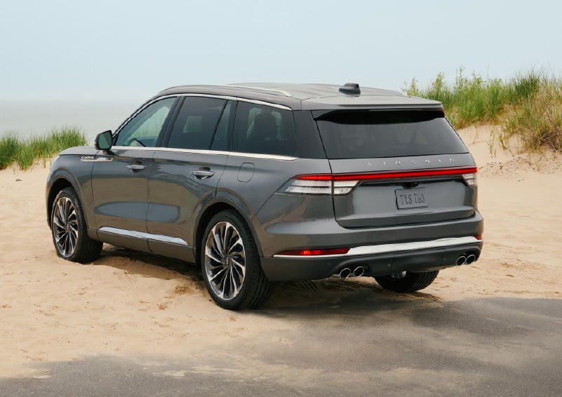 A 2027 Lincoln Aviator® SUV is parked next to sand dunes. | Dutch Miller Lincoln of Ashland in Ashland KY