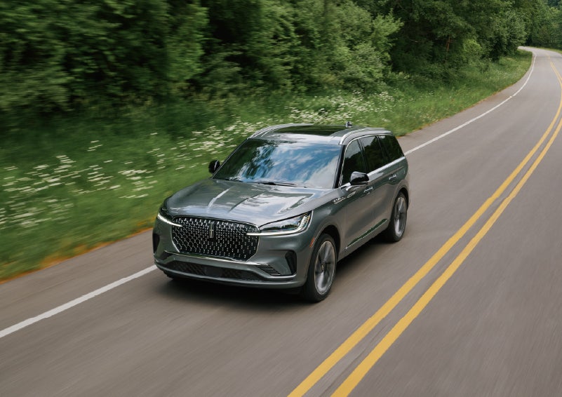 A 2027 Lincoln Aviator® SUV is being driven down a road. | Dutch Miller Lincoln of Ashland in Ashland KY