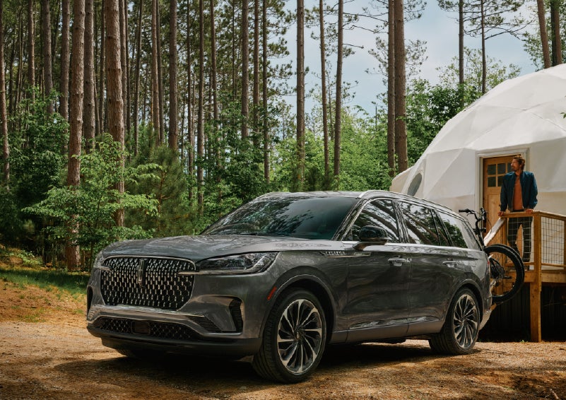A 2027 Lincoln Aviator® is parked next to a high end glamping site. | Dutch Miller Lincoln of Ashland in Ashland KY