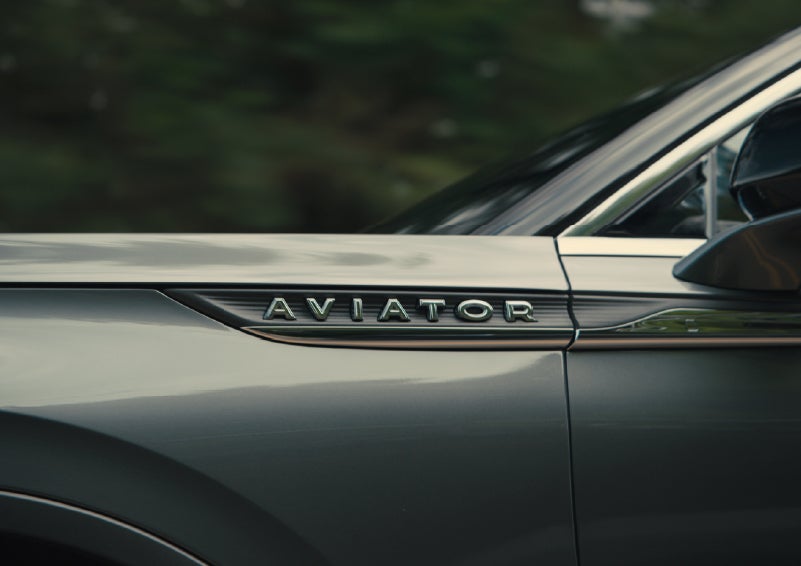 The driver’s side door and fender badging of a gray 2027 Lincoln Aviator® SUV are showcased. | Dutch Miller Lincoln of Ashland in Ashland KY