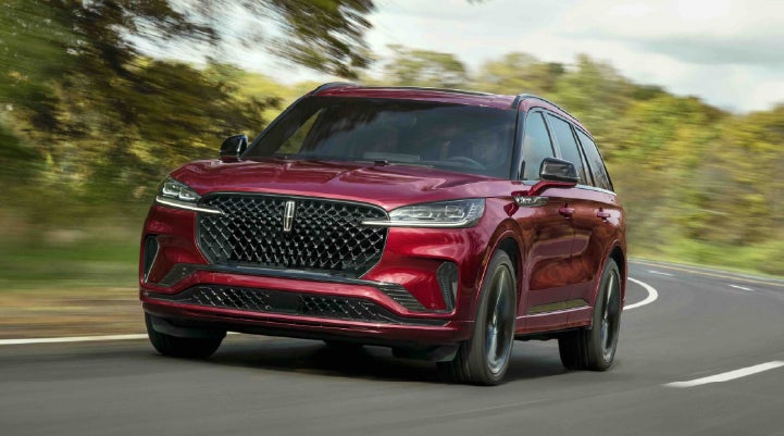 A 2027 Lincoln Aviator® SUV is being driven on a country road | Dutch Miller Lincoln of Ashland in Ashland KY