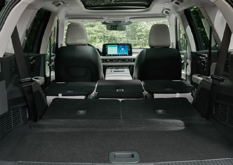 A rear to front view of the interior of a 2027 Lincoln Aviator® Black Label™ SUV shows the third and second rows folded flat | Dutch Miller Lincoln of Ashland in Ashland KY