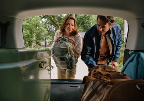 A couple loads luggage into the rear of a 2027 Lincoln Aviator® Black Label™ SUV..e 202 | Dutch Miller Lincoln of Ashland in Ashland KY