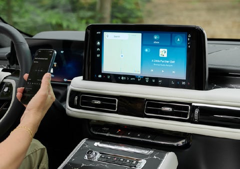 A person pairs thier phone with the center touchscreen of a 2027 Lincoln Aviator® Black Label™ SUV | Dutch Miller Lincoln of Ashland in Ashland KY